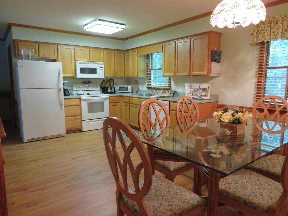 Kitchen has 2 refrigerators - one in kitchen and one in laundry room