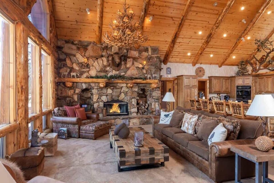 Towering Log accented Ceilings. Open floor plan to kitchen.