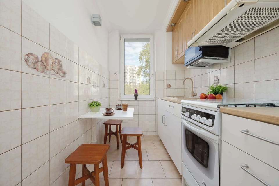 A cozy kitchen with a small dining table placed by the window, perfect for everyday meals.