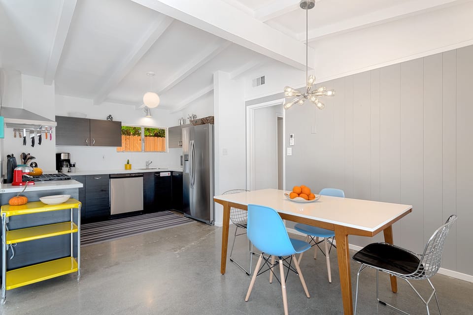 Swanky dining area open to kitchen and living area that seats up to 6 guests