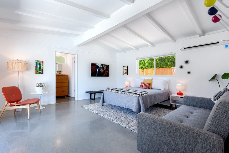 King bedroom suite with lounging area, walk-in closet, TV and ensuite bath