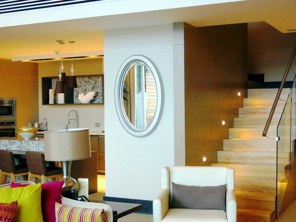 view from living area of kitchen and stairs to loft and second bedroom