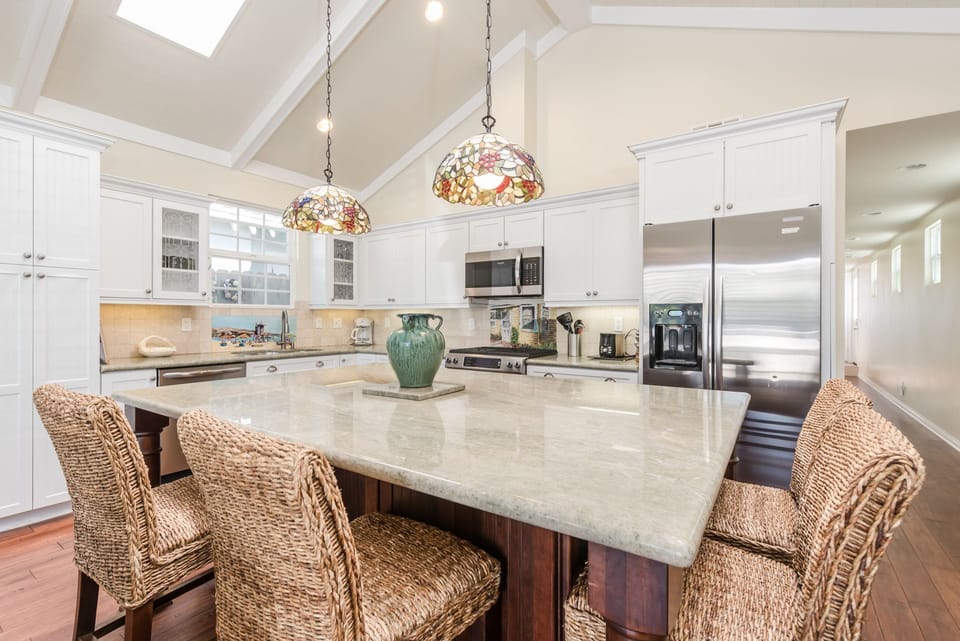 The large kitchen island serves as the indoor dining area.
                