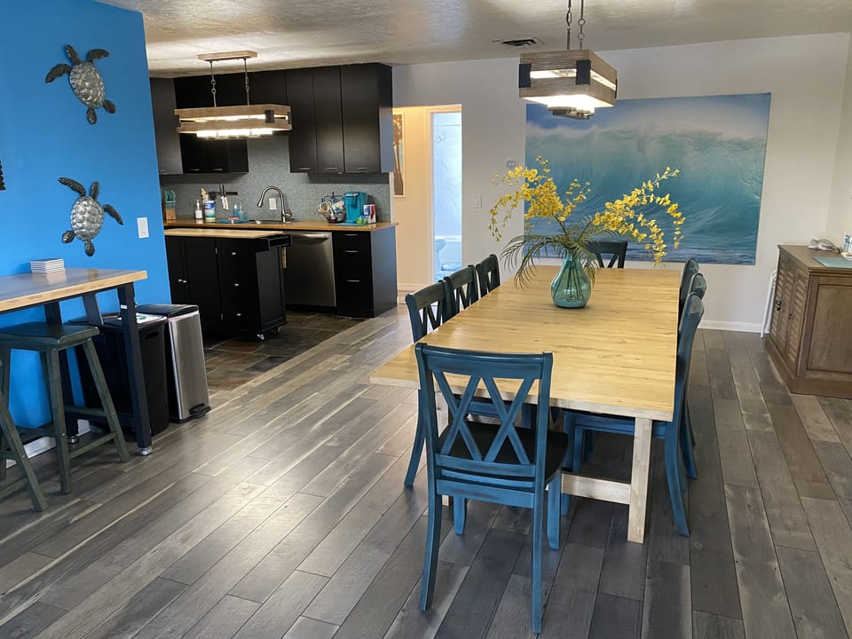 View into apartment. Large table w/ seating for 8 and tall table that seats 2