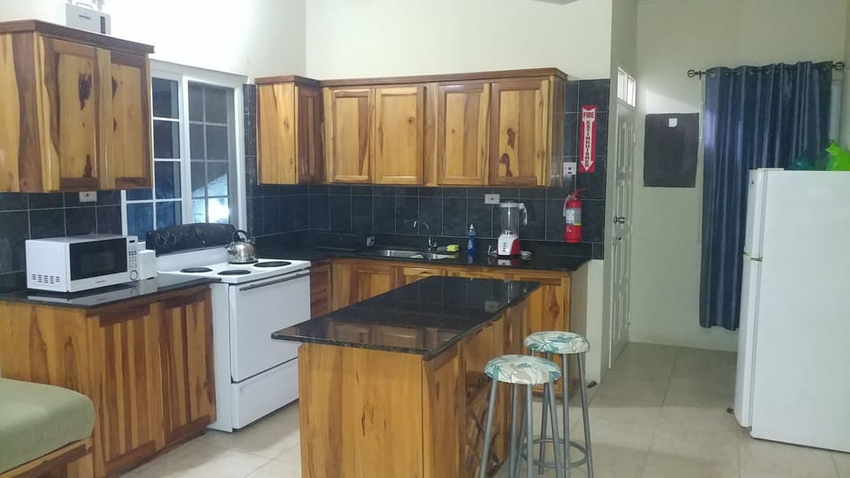 Kitchen with full size stove, refrigerator and microwave