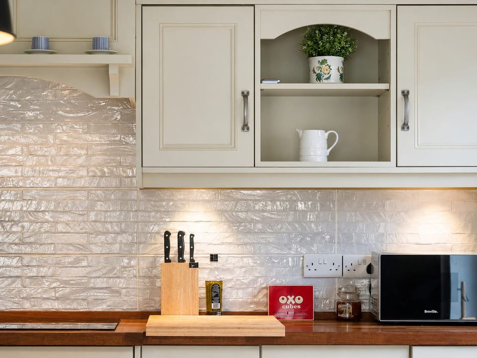 Bright designer kitchen with warm lighting and elegant finishes