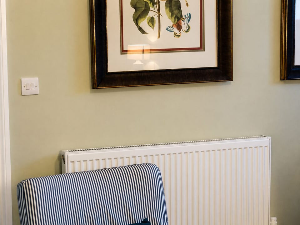 Cozy reading nook with botanical art and classic, inviting decor