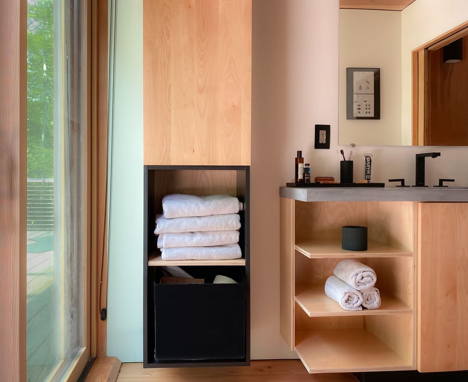 Main bathroom, plenty of towels, and sliding door to deck and outside shower.