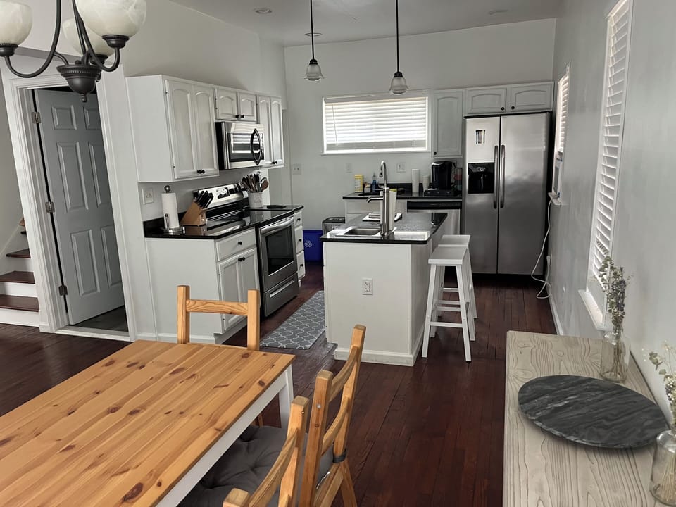 Kitchen area with granite counters, stainless appliances. 