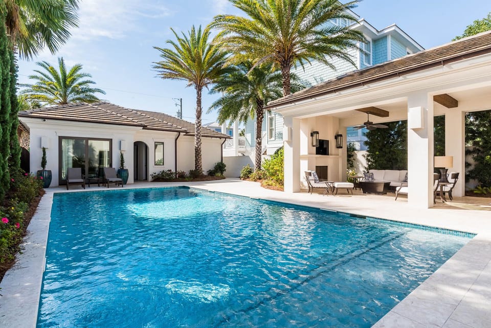 This outdoor living space features an outdoor kitchen, living area w/TV & more!