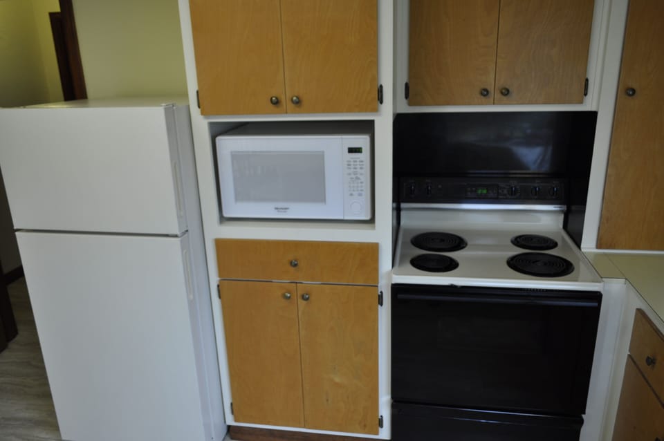 kitchen full size fridge, microwave, and oven.