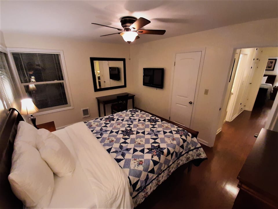 Front bedroom, entry, closet, TV, desk, dresser, queen bed