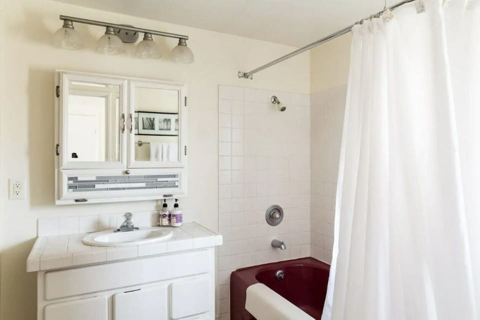 Full bath with tub/shower combination.