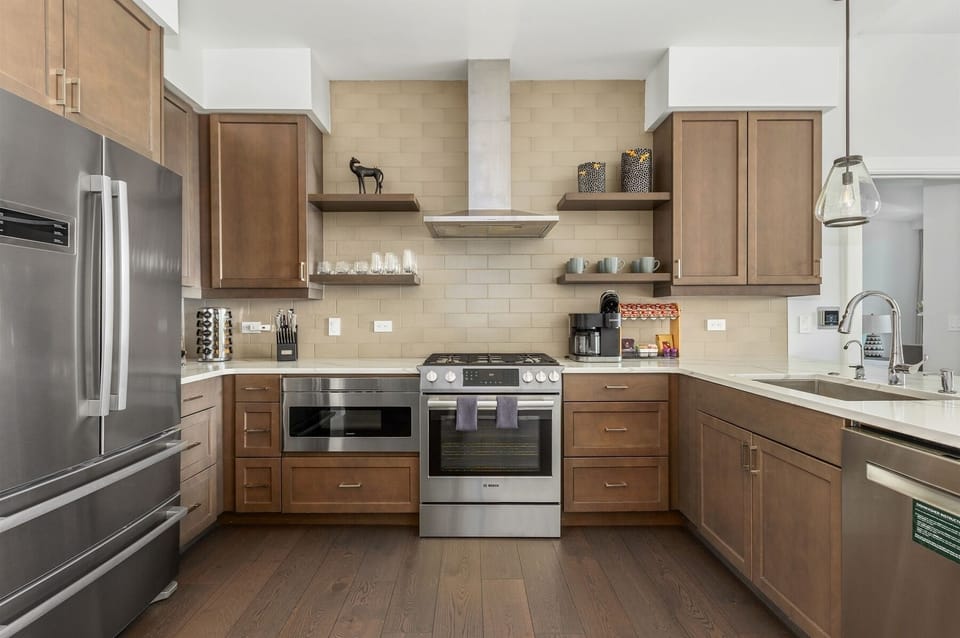 Kitchen with 5 burner gas stove, dishwasher, microwave, Keurig Duo and refrigerator