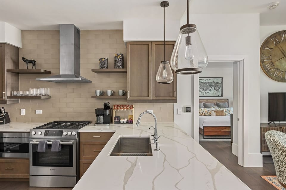Kitchen with 5 burner gas stove, dishwasher, microwave, Keurig Duo and refrigerator