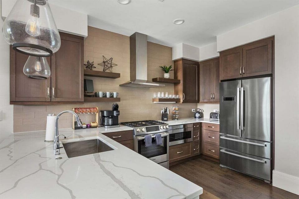 Kitchen with 5 burner gas stove, dishwasher, microwave, Keurig Duo and refrigerator