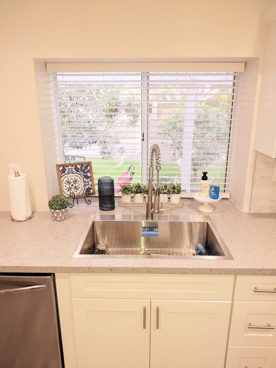 Sink with view of patio and mature fruit trees