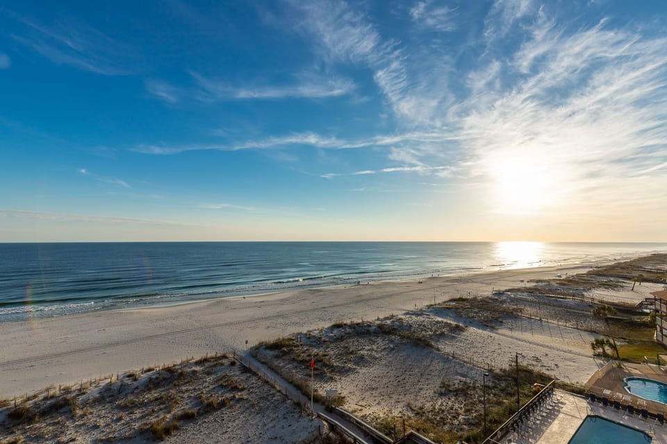This stunning beachfront view showcases serene waters and soft sands, perfect for a relaxing getaway