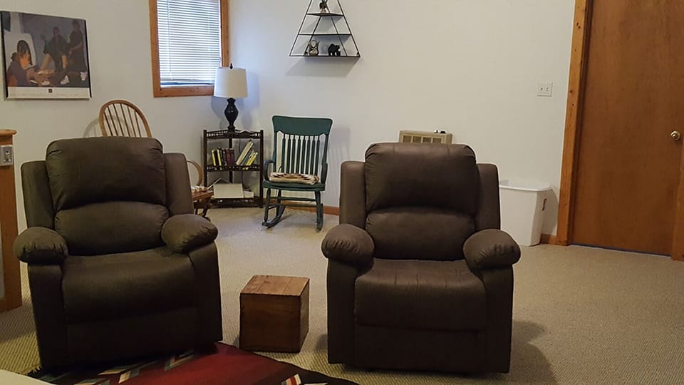 Upstairs loft has 2 comfy recliners, a queen bed, TV, futon and rocking chairs