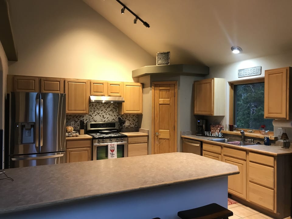 Large, fully stocked kitchen with breakfast bar.  