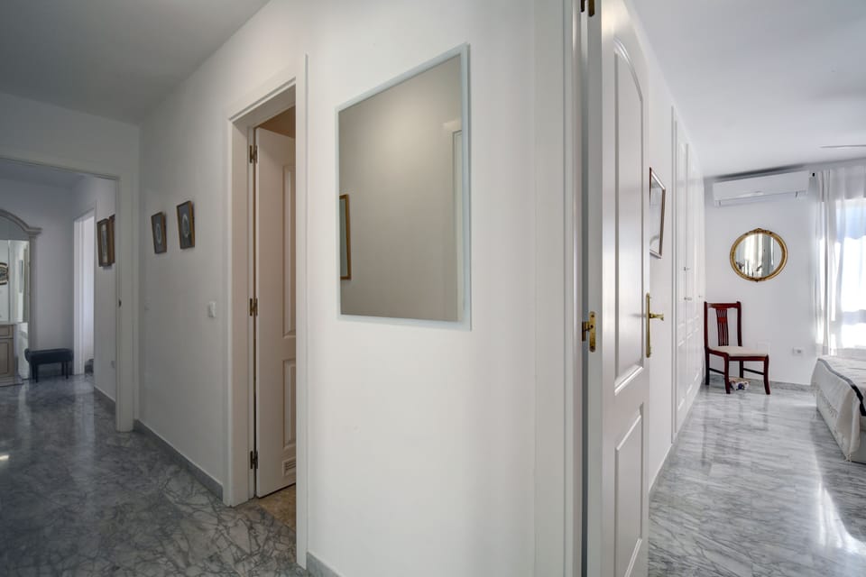 View towards front door, bathroom 2 middle of photo, main bedroom right.