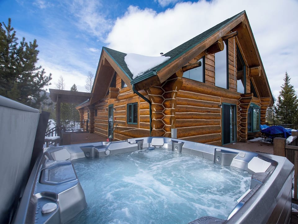 Soak in bubbling warmth while gazing at snow-dusted pines and dramatic mountain skies from your private hot tub.