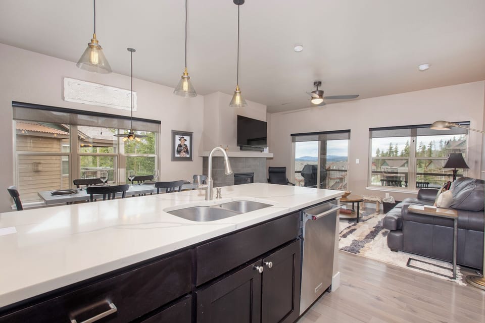 Gather around your spacious kitchen island where gleaming countertops and modern fixtures create the perfect heart for your mountain getaway.