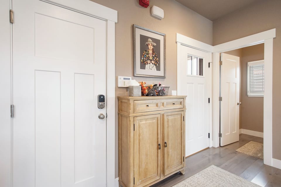 You'll love this welcoming entryway with beautiful hardwood floors, stylish furnishings, and thoughtful touches that make you feel instantly at home.