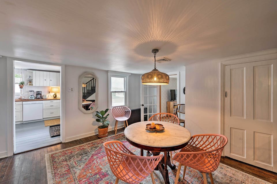 The shabby chic light fixture casts a warm glow over the breakfast table.