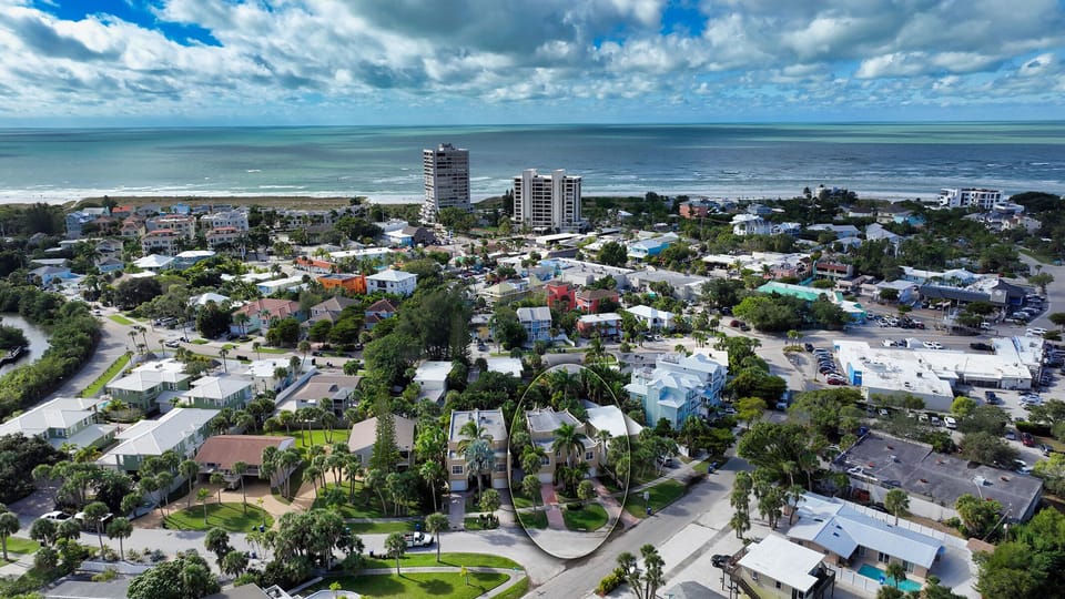You're here! Just 1 mile from world-famous Siesta Key Beach—shown here from above with your vacation home nestled nearby.
