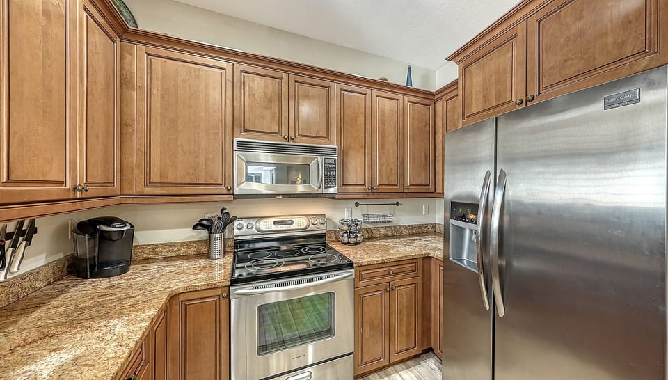Stainless appliances, ample prep space, and coffee center for early beach mornings.