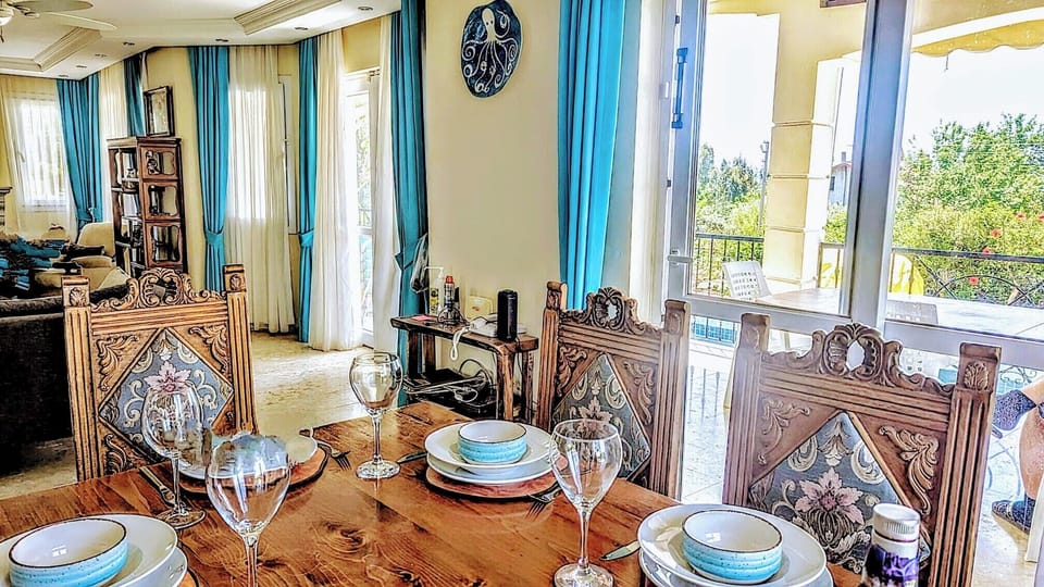 Indoors dinner table next to the kitchen.