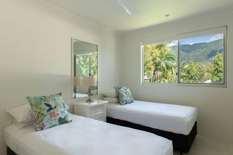 Leafy views continue in the second king-sized bedroom. It offers air-conditioning and the option to split into two singles on request.