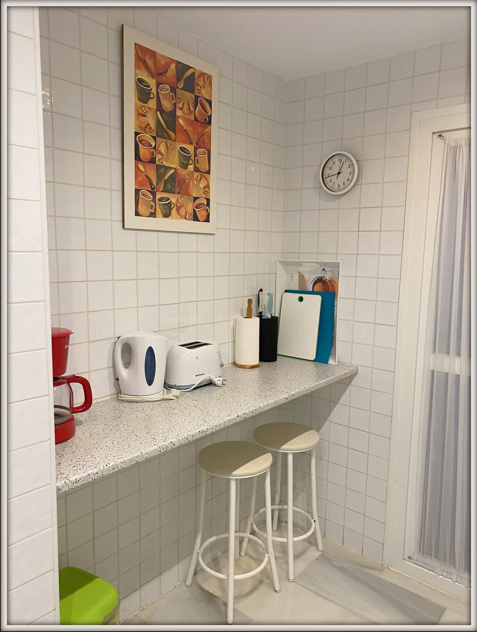 Fully equipped kitchen leading to utility area with washing machine