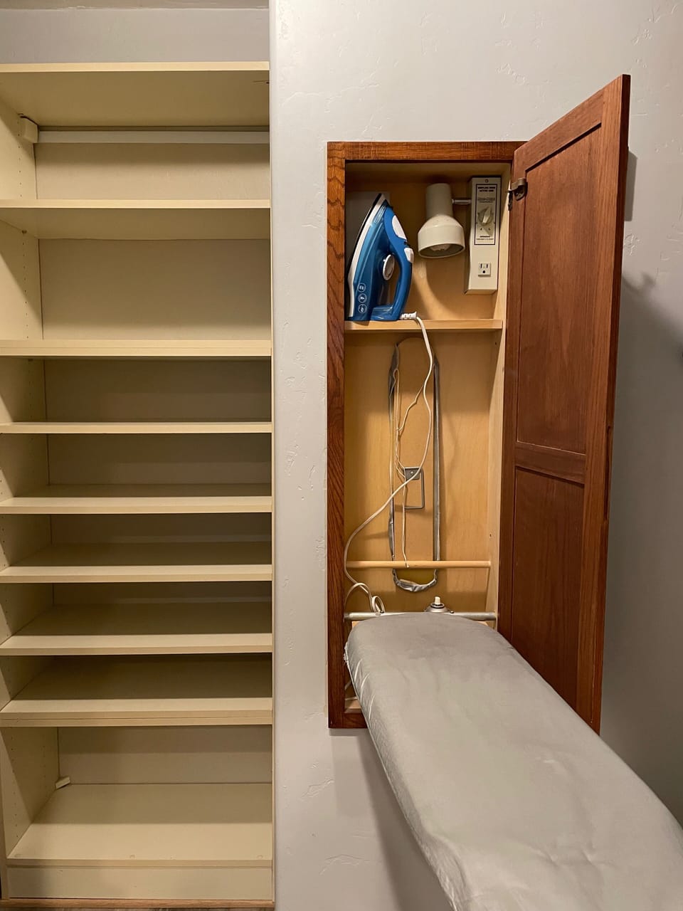 cool pop out iron and ironing board in walk in closet