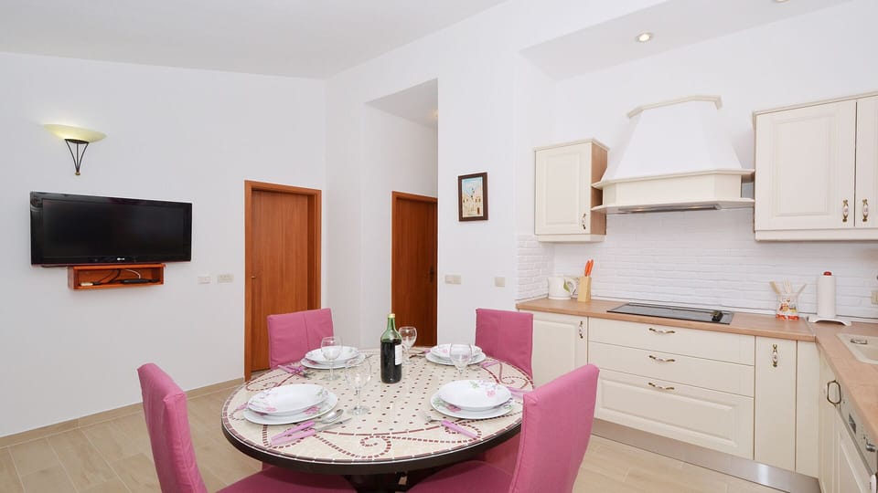 Dinning area with LCD SAT TV and top quality AC - top floor apt. ANYA