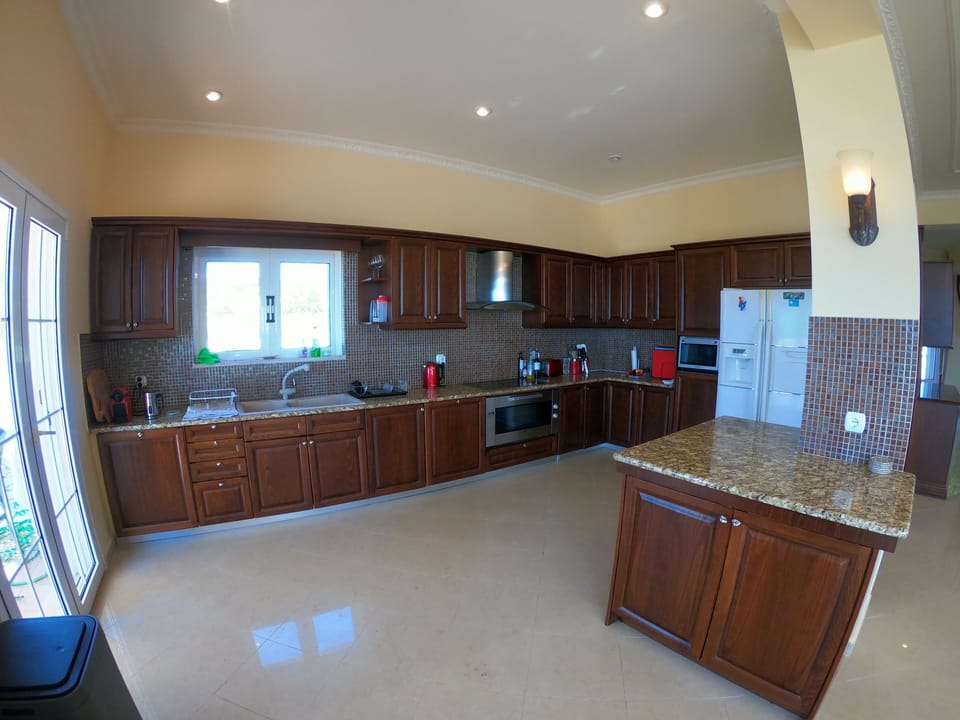Kitchen with 2 dishwashers, large fridge freezer, double sinks, hob and oven