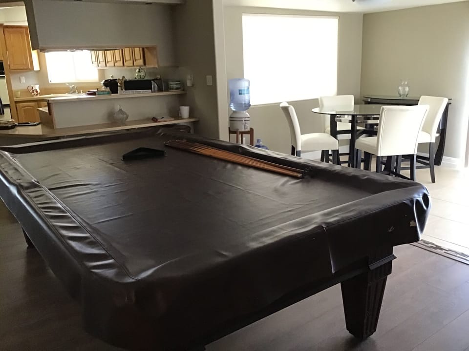 Pool table,brkfst  bar,Dining area overlooking spacious fenced back yard pool
