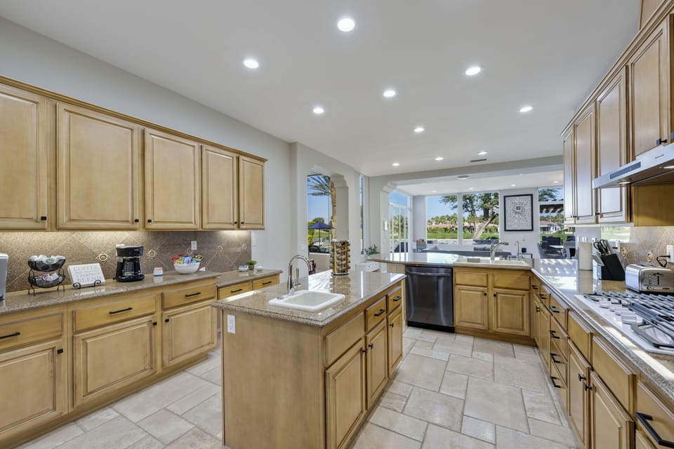 Large fully stocked kitchen with views overlooking pool and 18th fairway