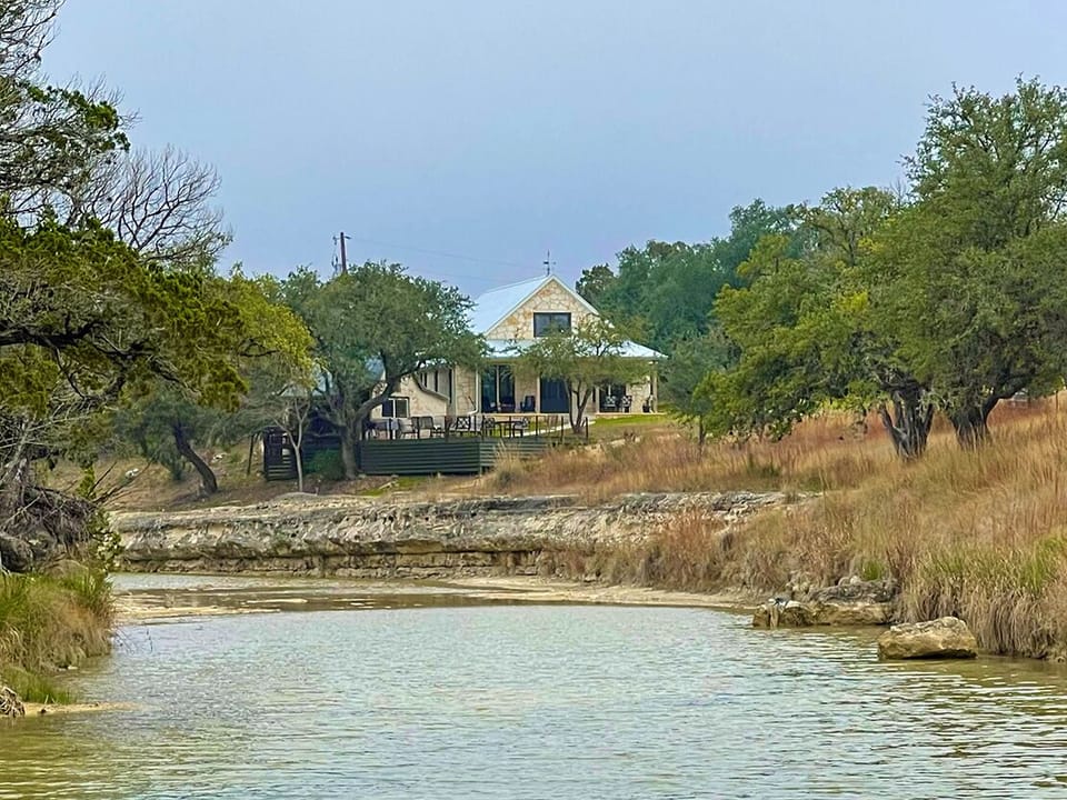 A beautiful stone house on a texas limestone bottom creek