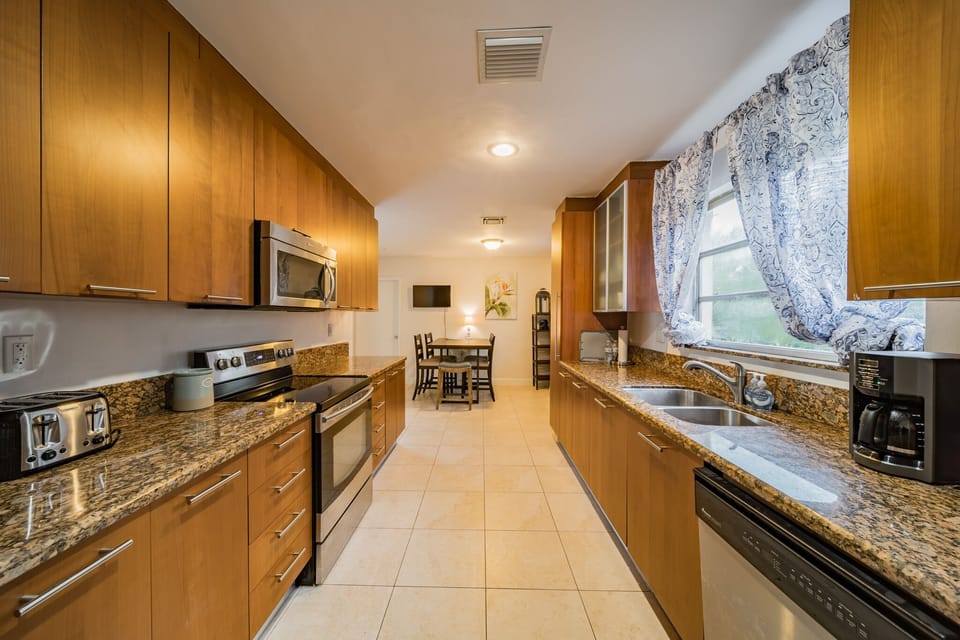 Kitchen:
View of Sink, Refrigerator, Stove, Microwave, Cabinetry, Breakfast Tabl