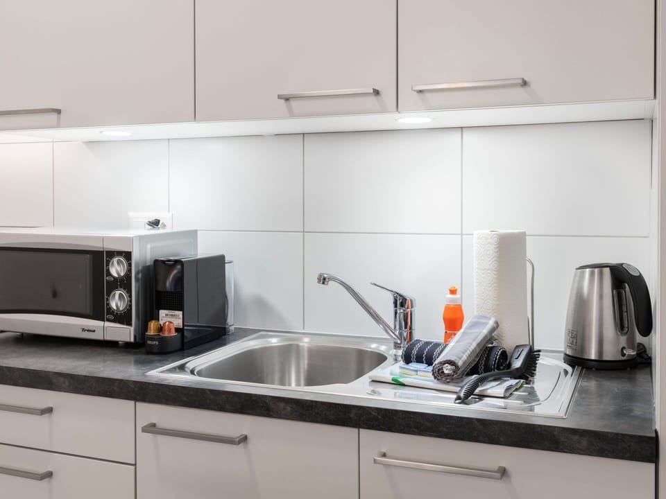 Tap, Kitchen Sink, Cabinetry, Sink, Countertop, Plumbing Fixture, Kitchen Stove, Kitchen, Interior Design, Kitchen Appliance
