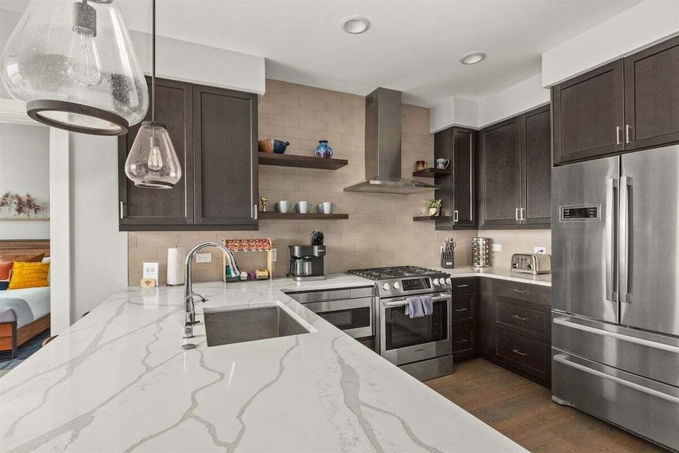Kitchen with 5 burner gas stove, dishwasher, microwave, Keurig and refrigerator