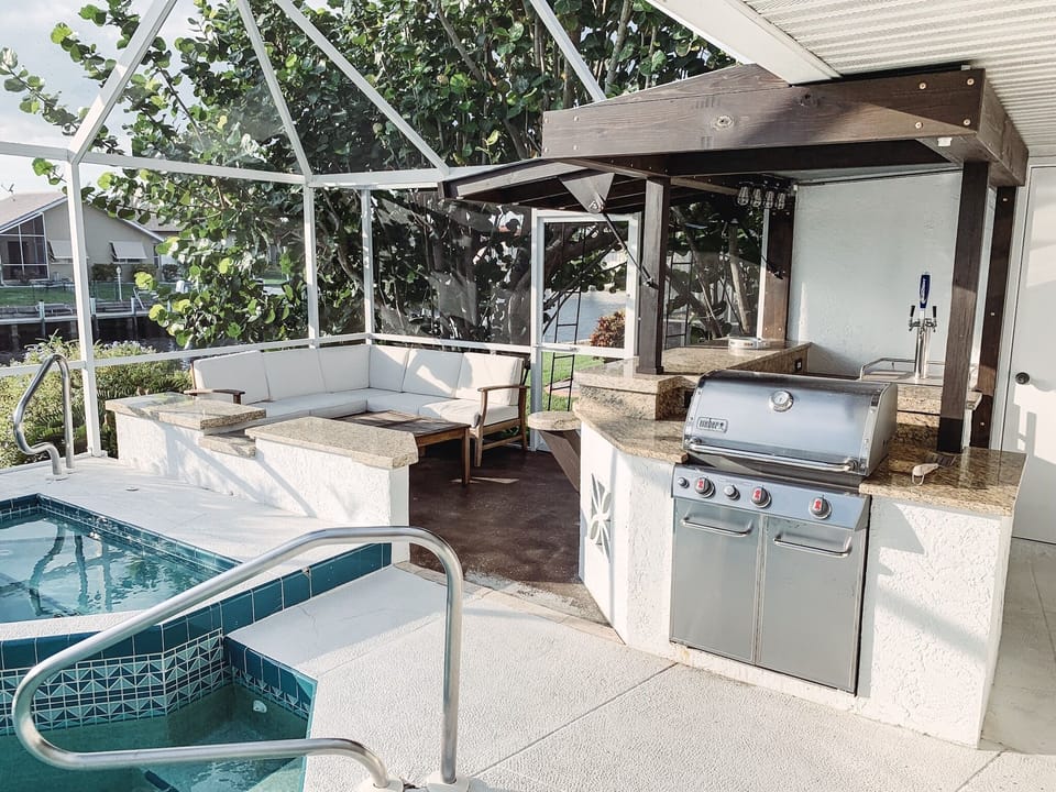 Beautiful area also features an outdoor kitchen, sitting area, & fire pit!