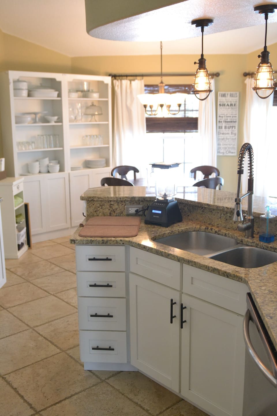 Kitchen is open to dining/living area & features natural stone tile flooring.
