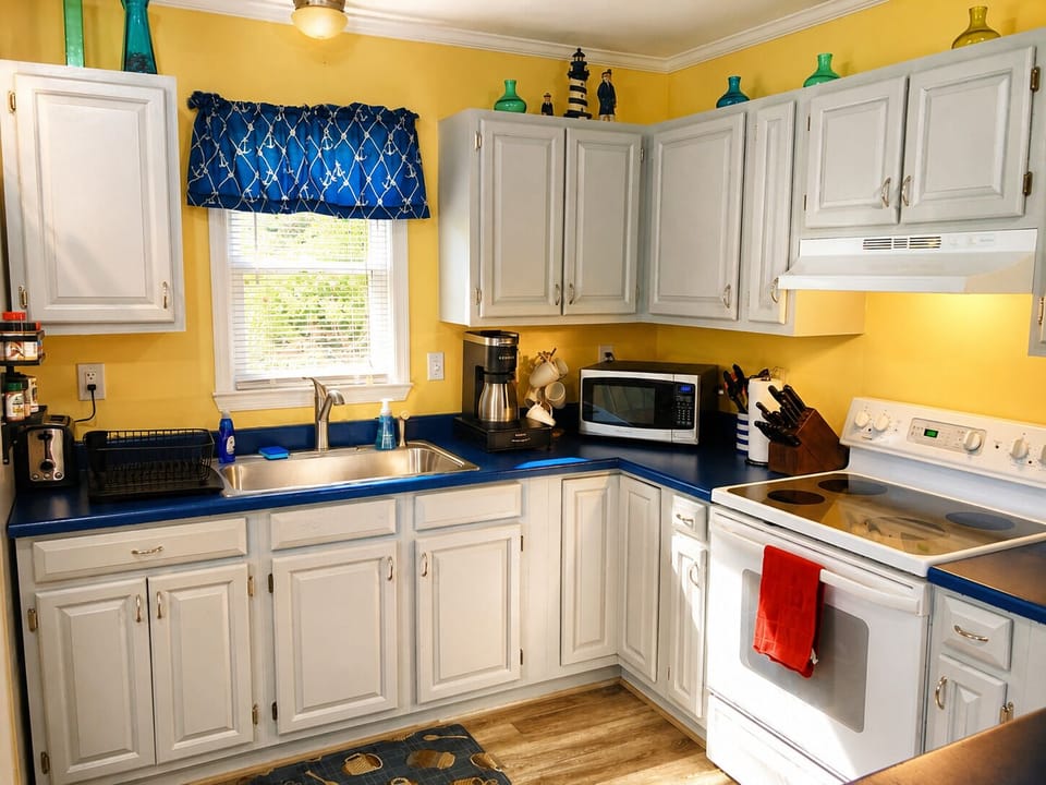 The kitchen boasts an extra deep sink, a Keurig that brews single cups or carafes, microwave, tea kettle, and more in this fully stocked kitchen!  And the open floorplan means you can cook and not miss any of movie or game night in the living room!
