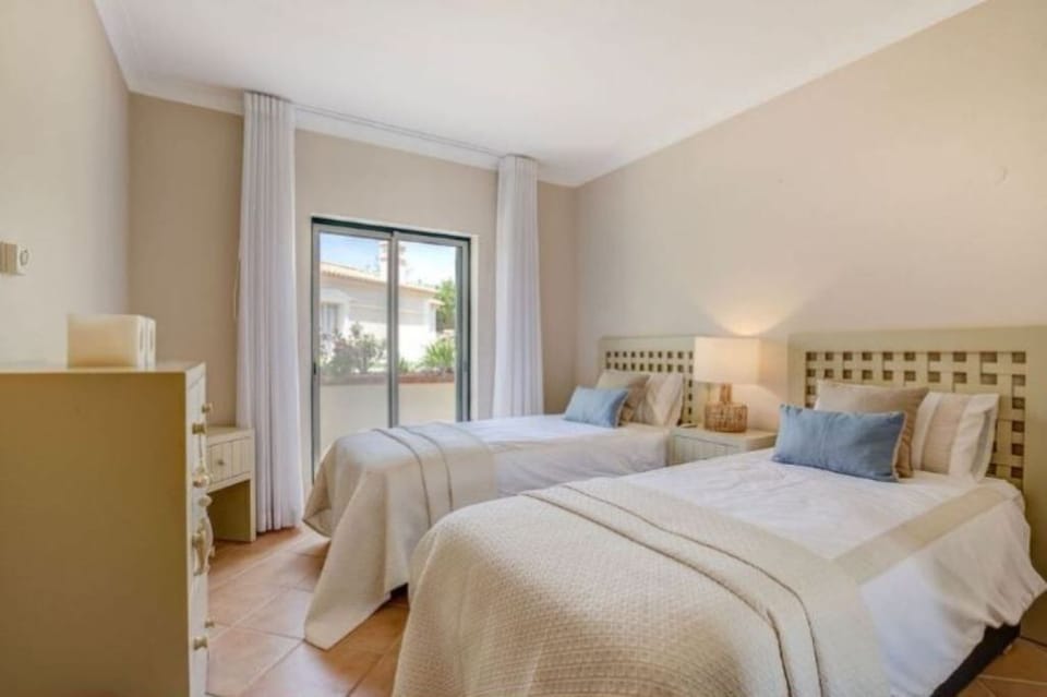 Twin bedded room at back of house with electric shutters 