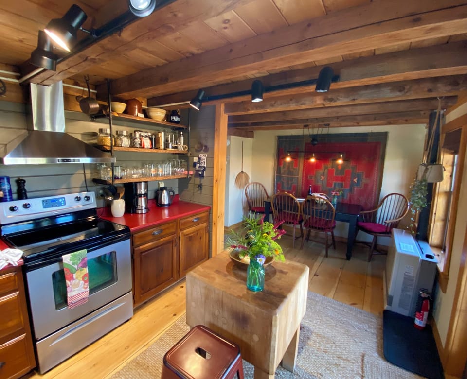 The kitchen is cozy, fully stocked, and full of classic log cabin charm.