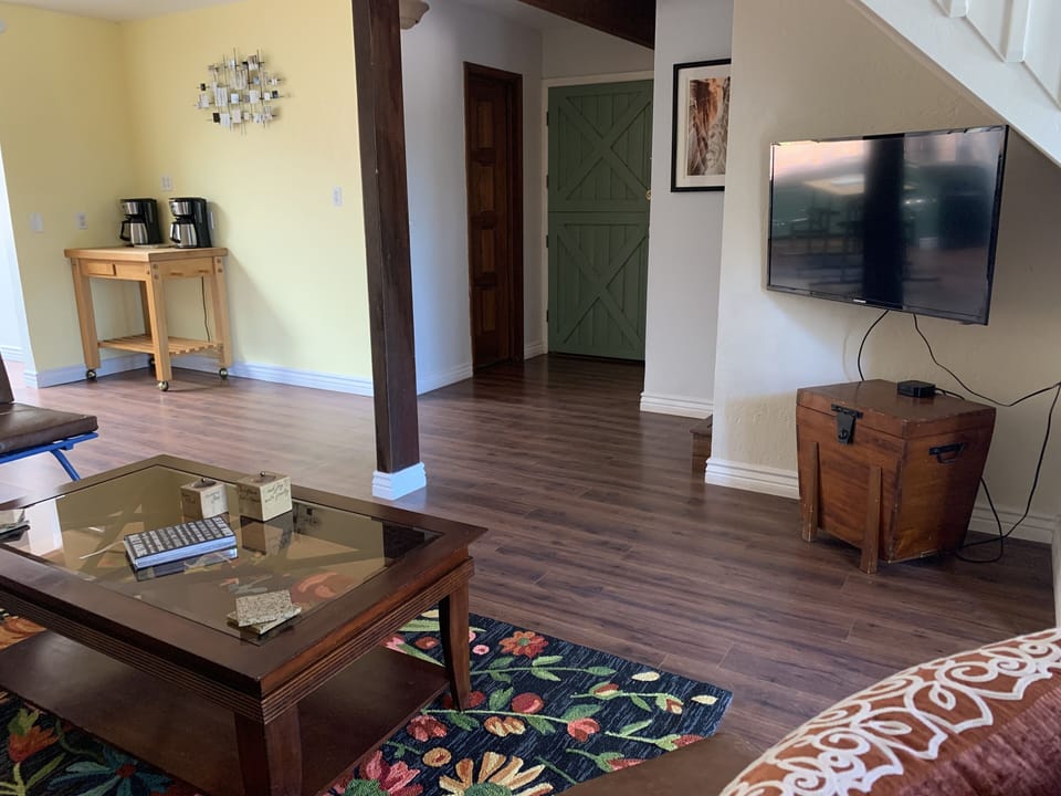 Two coffee makers with butcher block rolling bar. Smart TV with Apple TV