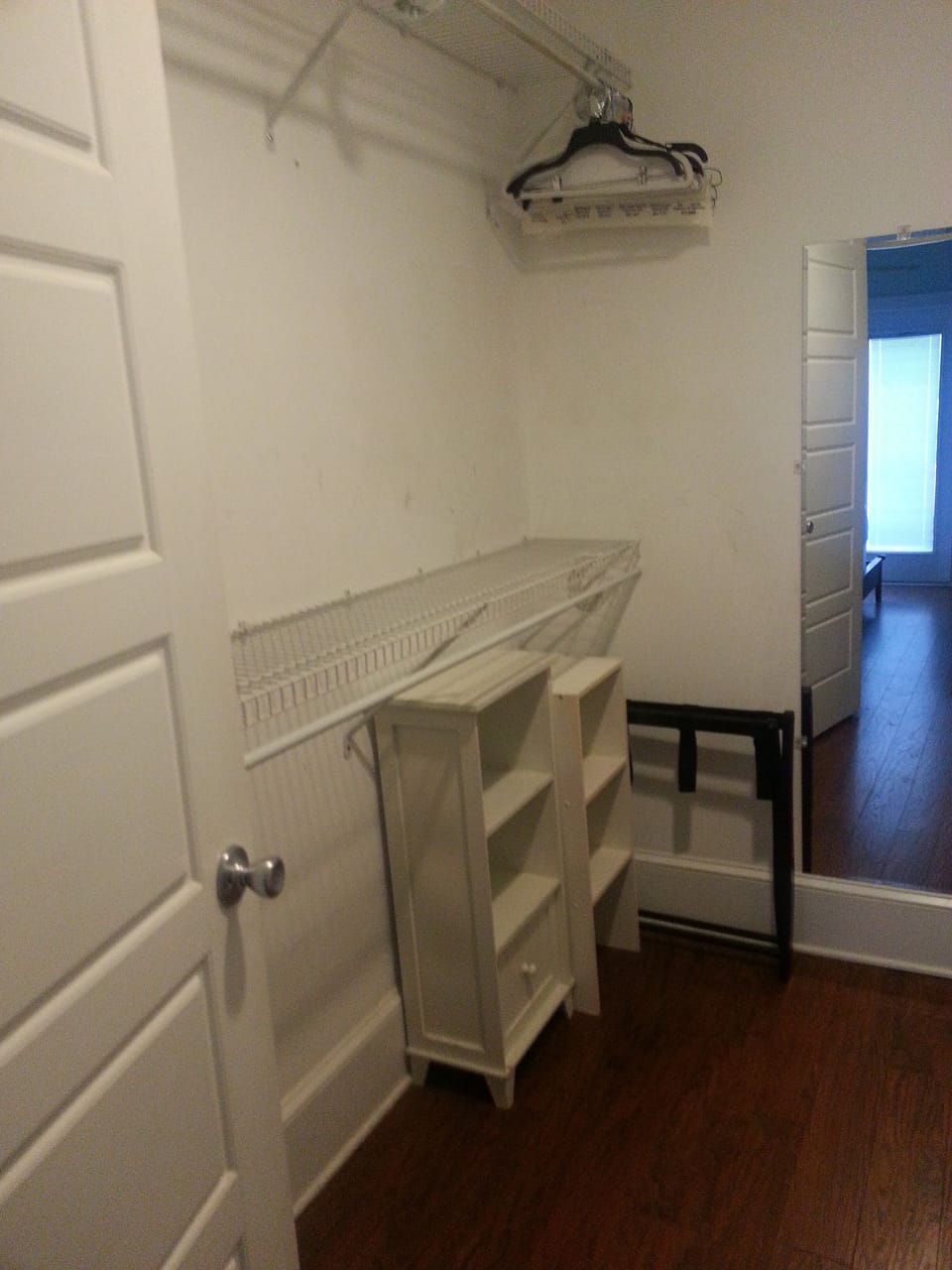 Master walk-in closet. Hangers, suitcase stand, shoe shelfs.